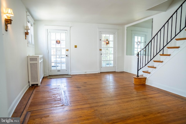 8 Oakley Rd, Upper Darby, PA 19082 - foyer featuring wood finished floors, stairs, plenty of natural light, and radiator heating unit