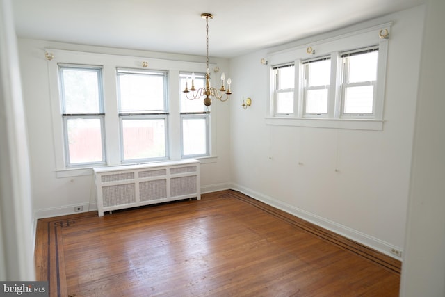 8 Oakley Rd, Upper Darby, PA 19082 - empty room with radiator, a chandelier, and wood finished floors