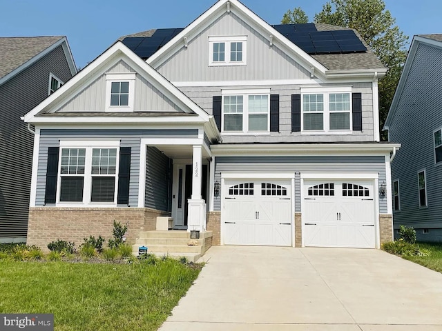 122 Boxelder Dr, Stafford, VA 22554 - craftsman-style house with solar panels, an attached garage, driveway, board and batten siding, and brick siding