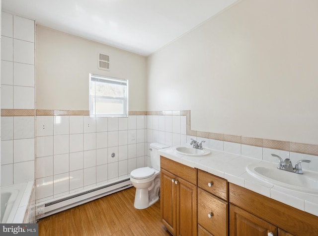 909 Spruce Ave, Pleasantville, NJ 08232 - full bath featuring tile walls, visible vents, a sink, and a baseboard heating unit