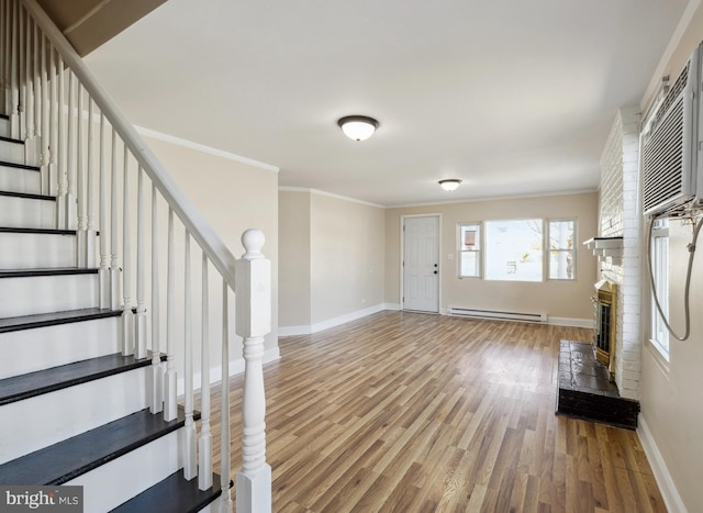 909 Spruce Ave, Pleasantville, NJ 08232 - foyer with stairs, a fireplace, wood finished floors, ornamental molding, and baseboard heating