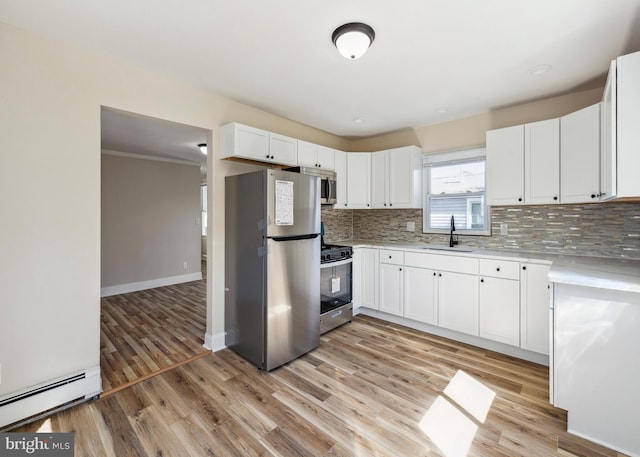 909 Spruce Ave, Pleasantville, NJ 08232 - kitchen with light wood finished floors, a baseboard radiator, stainless steel appliances, a sink, and backsplash