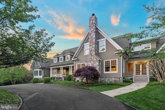 11820 Plantation Dr, Great Falls, VA 22066 - shingle-style home featuring a porch, french doors, a chimney, a front lawn, and stone siding