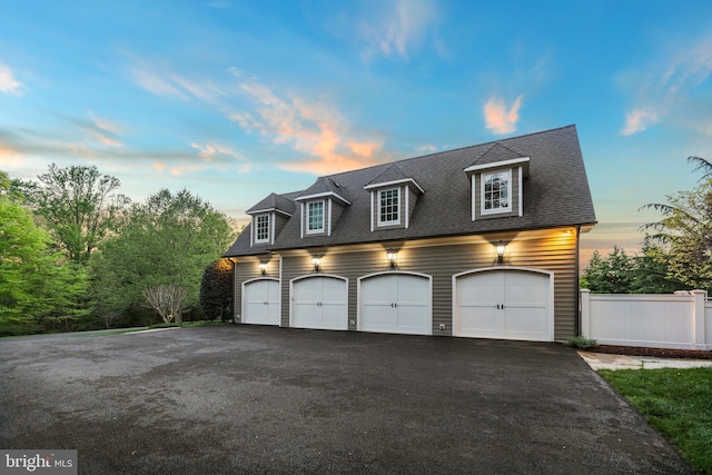 11820 Plantation Dr, Great Falls, VA 22066 - garage at dusk featuring fence and driveway