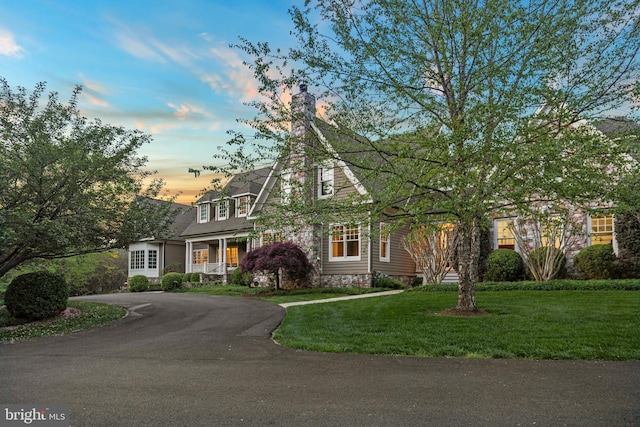11820 Plantation Dr, Great Falls, VA 22066 - view of front of home featuring curved driveway, covered porch, and a front yard