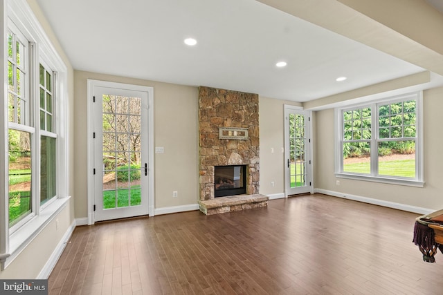 11820 Plantation Dr, Great Falls, VA 22066 - unfurnished living room with a stone fireplace, plenty of natural light, baseboards, and dark wood-type flooring