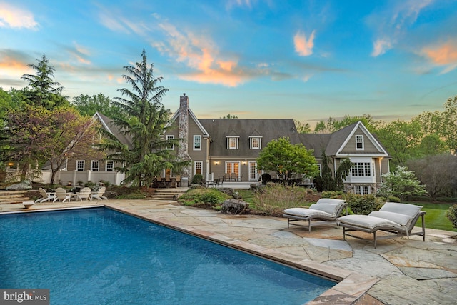 11820 Plantation Dr, Great Falls, VA 22066 - pool at dusk with a patio and an outdoor pool