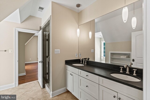 11820 Plantation Dr, Great Falls, VA 22066 - full bath featuring a sink, vaulted ceiling, double vanity, and visible vents