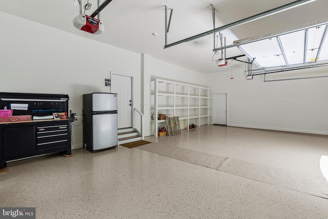 11820 Plantation Dr, Great Falls, VA 22066 - garage featuring baseboards, freestanding refrigerator, and a garage door opener