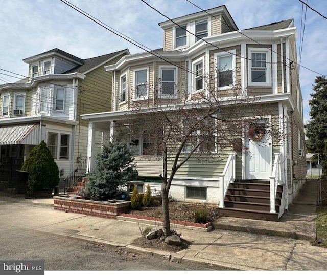 american foursquare style home featuring entry steps