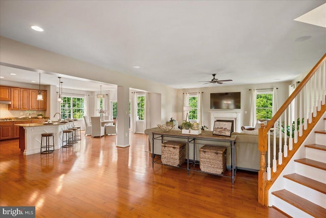 12670 Perrywood Ln, Dunkirk, MD 20754 - living room featuring a ceiling fan, plenty of natural light, wood finished floors, a fireplace, and recessed lighting