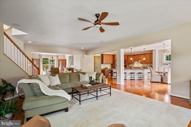 12670 Perrywood Ln, Dunkirk, MD 20754 - living room with a chandelier, light wood-type flooring, stairway, ceiling fan, and recessed lighting