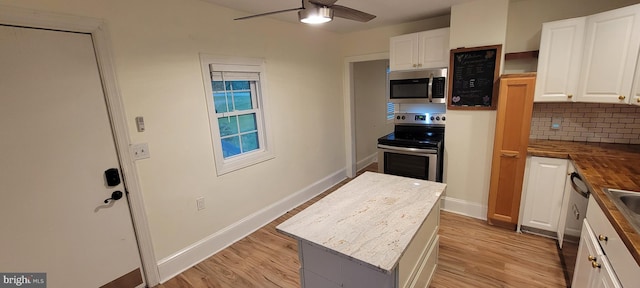 2920 Dares Beach Rd, Prince Frederick, MD 20678 - kitchen featuring stainless steel appliances, wooden counters, a kitchen island, and white cabinetry