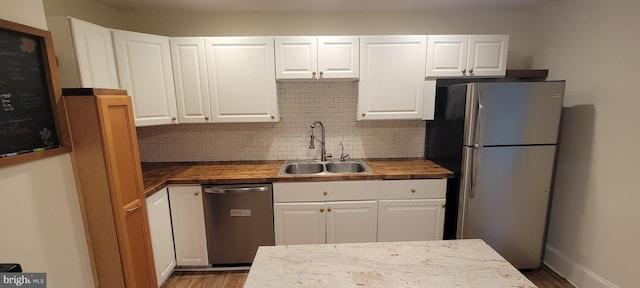 2920 Dares Beach Rd, Prince Frederick, MD 20678 - kitchen with stainless steel appliances, a sink, wood counters, backsplash, and wood finished floors