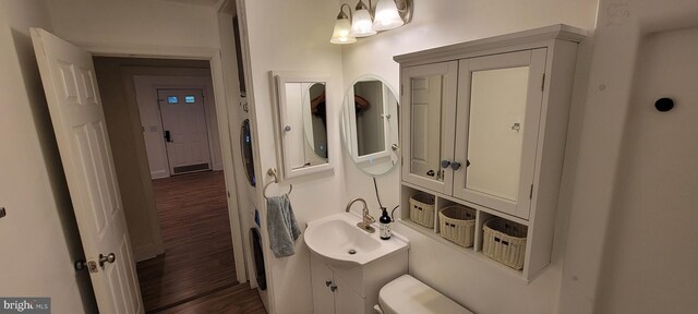 2920 Dares Beach Rd, Prince Frederick, MD 20678 - bathroom featuring wood finished floors, toilet, and vanity