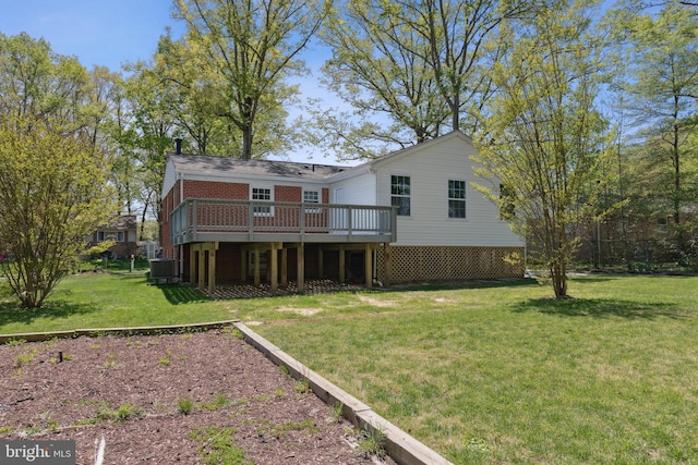 rear view of house featuring central AC unit, brick siding, a yard, and a deck