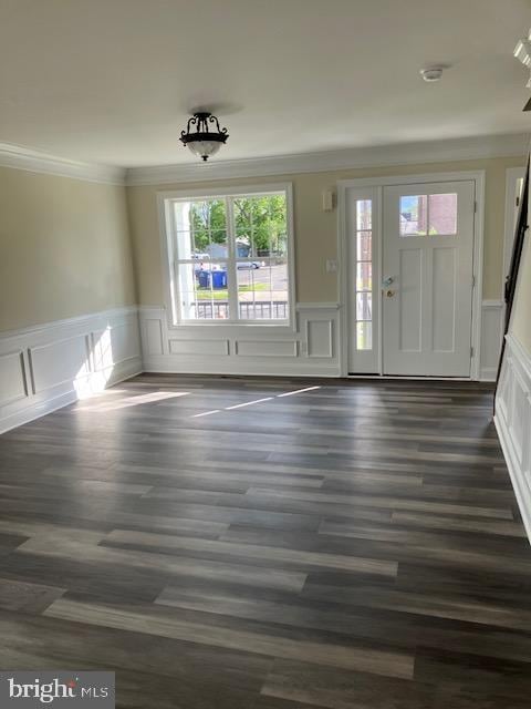 111 Heulings Ave, Riverside, NJ 08075 - unfurnished living room featuring crown molding, wainscoting, a decorative wall, and dark wood-style flooring