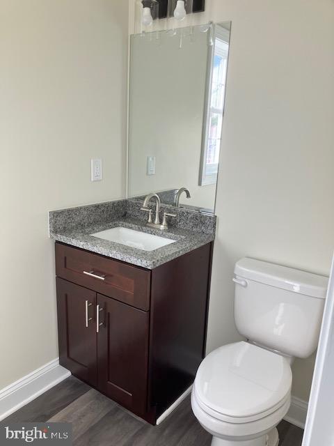 111 Heulings Ave, Riverside, NJ 08075 - bathroom with vanity, toilet, wood finished floors, and baseboards