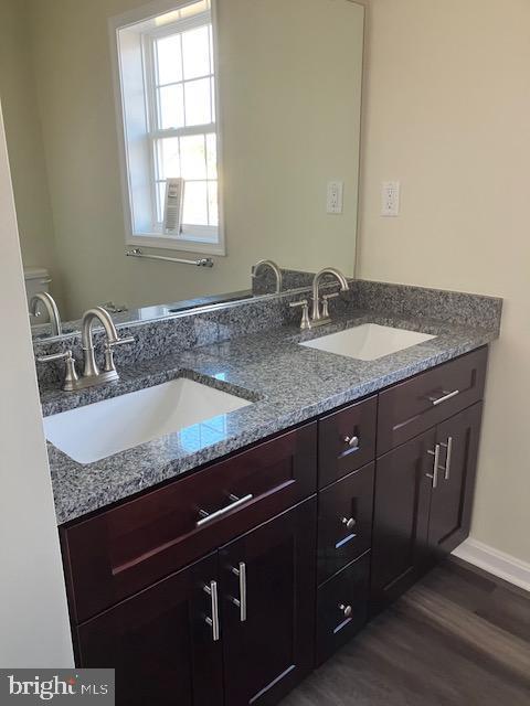 111 Heulings Ave, Riverside, NJ 08075 - bathroom with double vanity, wood finished floors, and toilet