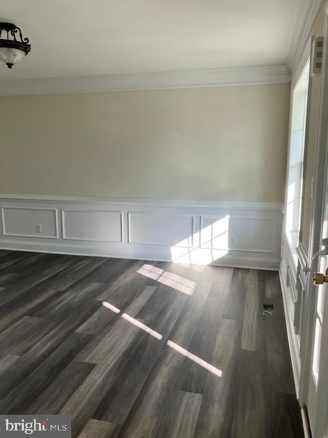 111 Heulings Ave, Riverside, NJ 08075 - unfurnished room with crown molding, a wainscoted wall, dark wood finished floors, and a decorative wall