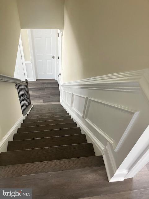 111 Heulings Ave, Riverside, NJ 08075 - staircase with a decorative wall, wainscoting, and wood finished floors