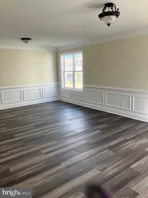 111 Heulings Ave, Riverside, NJ 08075 - spare room with ornamental molding, dark wood-style flooring, and a wainscoted wall