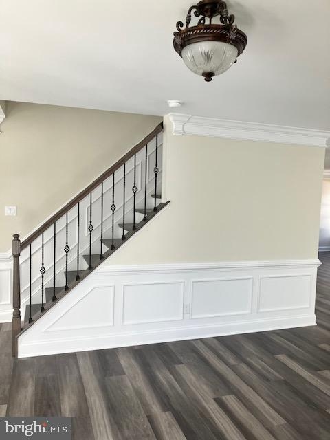 111 Heulings Ave, Riverside, NJ 08075 - stairway with wainscoting, ornamental molding, wood finished floors, and a decorative wall