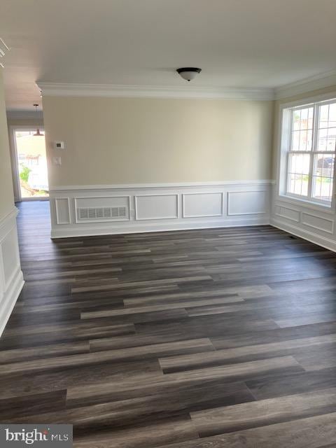 111 Heulings Ave, Riverside, NJ 08075 - empty room featuring ornamental molding, plenty of natural light, a decorative wall, dark wood-style floors, and a wainscoted wall
