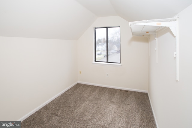 bonus room with baseboards, vaulted ceiling, and carpet