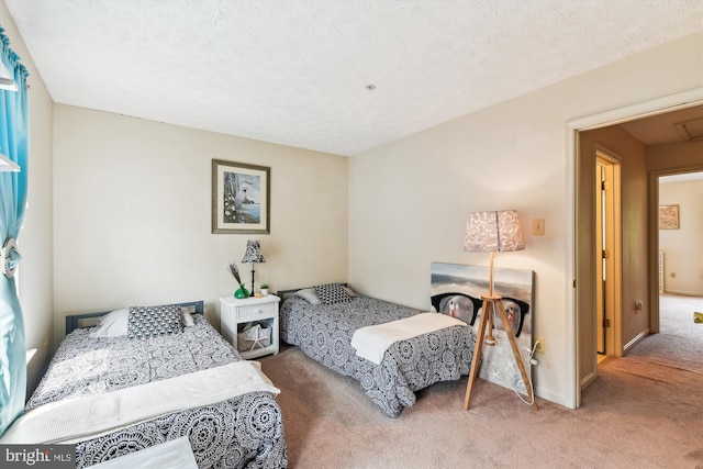 bedroom with a textured ceiling and carpet floors