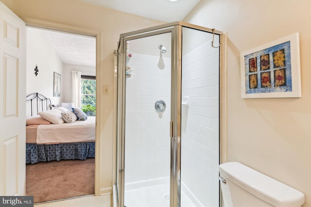 full bath featuring toilet, connected bathroom, and a shower stall