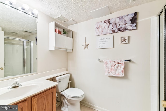full bath featuring tile patterned floors, toilet, vanity, a stall shower, and a textured ceiling