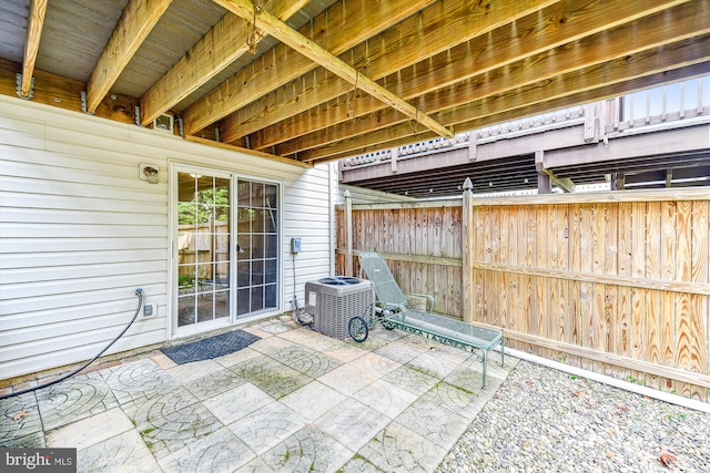 view of patio with cooling unit and fence