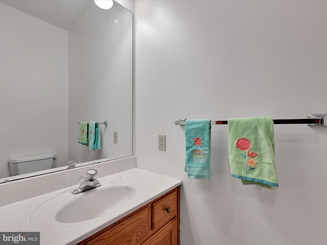 half bathroom featuring toilet and vanity