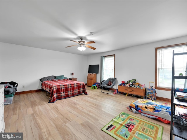 bedroom with baseboards, a ceiling fan, and wood finished floors