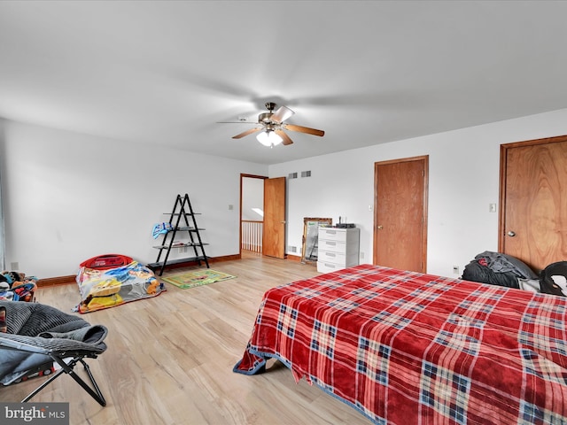 bedroom featuring baseboards, ceiling fan, and wood finished floors