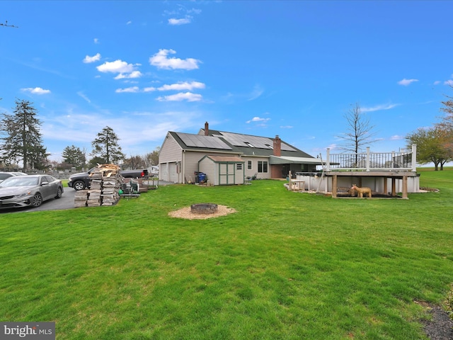 view of yard with a fire pit and an outbuilding