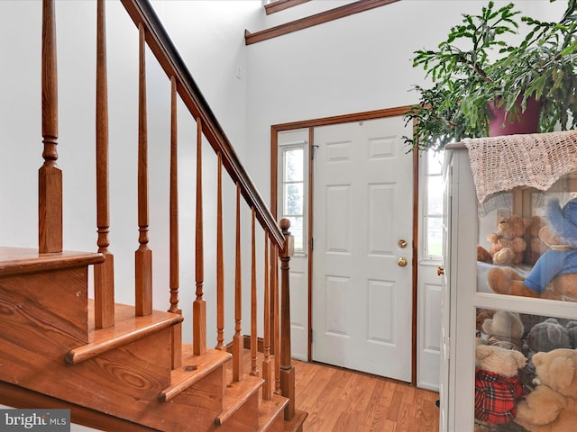 foyer with stairs and light wood-style floors
