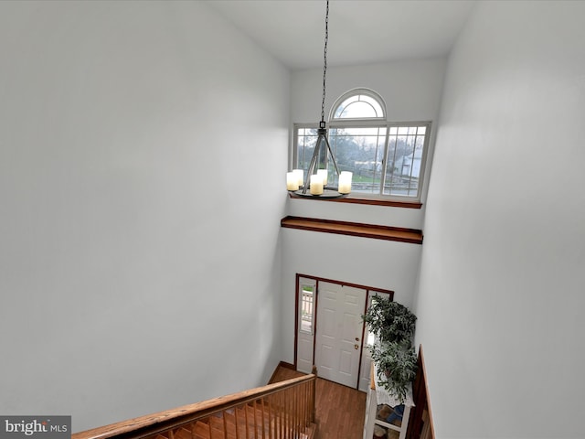 foyer entrance featuring a chandelier and wood finished floors