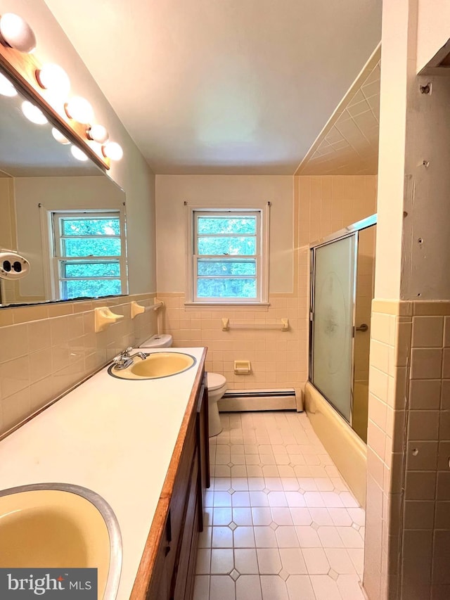 13306 Partridge Dr, Silver Spring, MD 20904 - full bath with tile walls, a baseboard radiator, tile patterned floors, double vanity, and toilet