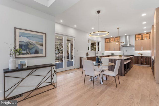 dining room featuring a notable chandelier, french doors, light wood finished floors, visible vents, and recessed lighting