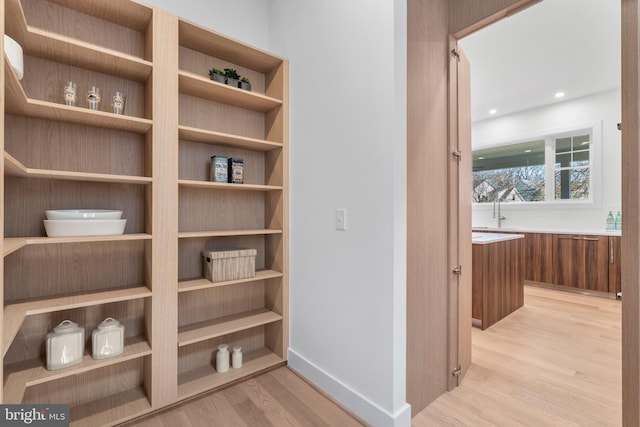 hallway with light wood-style flooring and recessed lighting