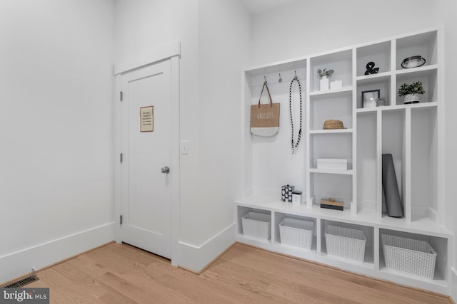 mudroom featuring visible vents, baseboards, and light wood-type flooring
