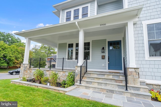 view of exterior entry with covered porch