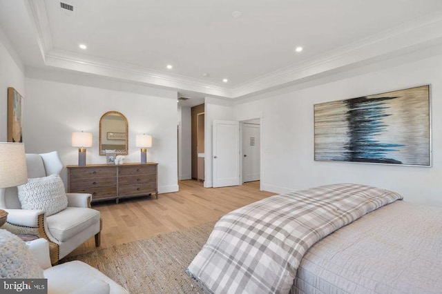 bedroom featuring light wood finished floors, recessed lighting, crown molding, and a raised ceiling