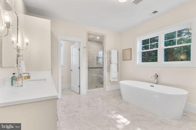 bathroom with a stall shower, marble finish floor, visible vents, and a freestanding tub