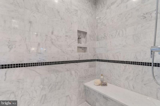 bathroom with tiled shower
