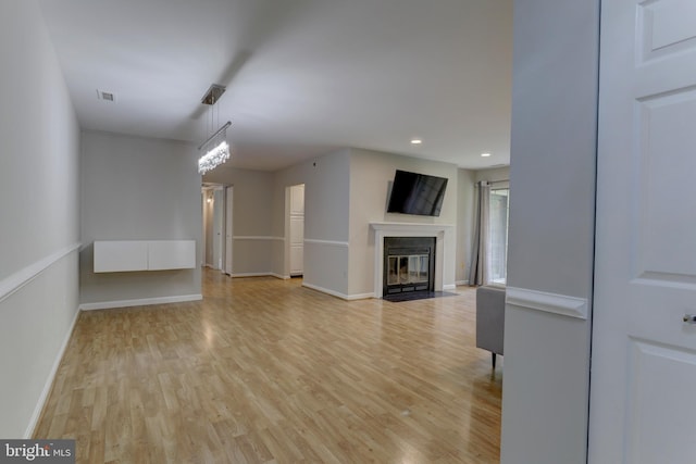 2 Rainflower Path Unit 102, Sparks Glencoe, MD 21152 - unfurnished living room featuring light wood-type flooring, a fireplace with flush hearth, baseboards, and recessed lighting