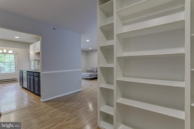 2 Rainflower Path Unit 102, Sparks Glencoe, MD 21152 - corridor with light wood-type flooring, baseboard heating, recessed lighting, a sink, and baseboards