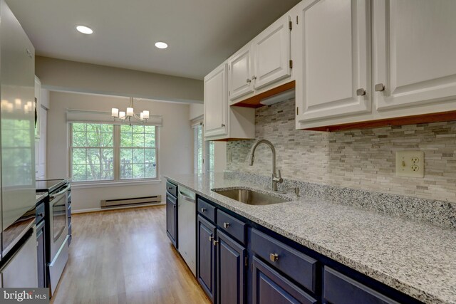 2 Rainflower Path Unit 102, Sparks Glencoe, MD 21152 - kitchen with a sink, a baseboard radiator, blue cabinets, light wood-type flooring, and white cabinetry
